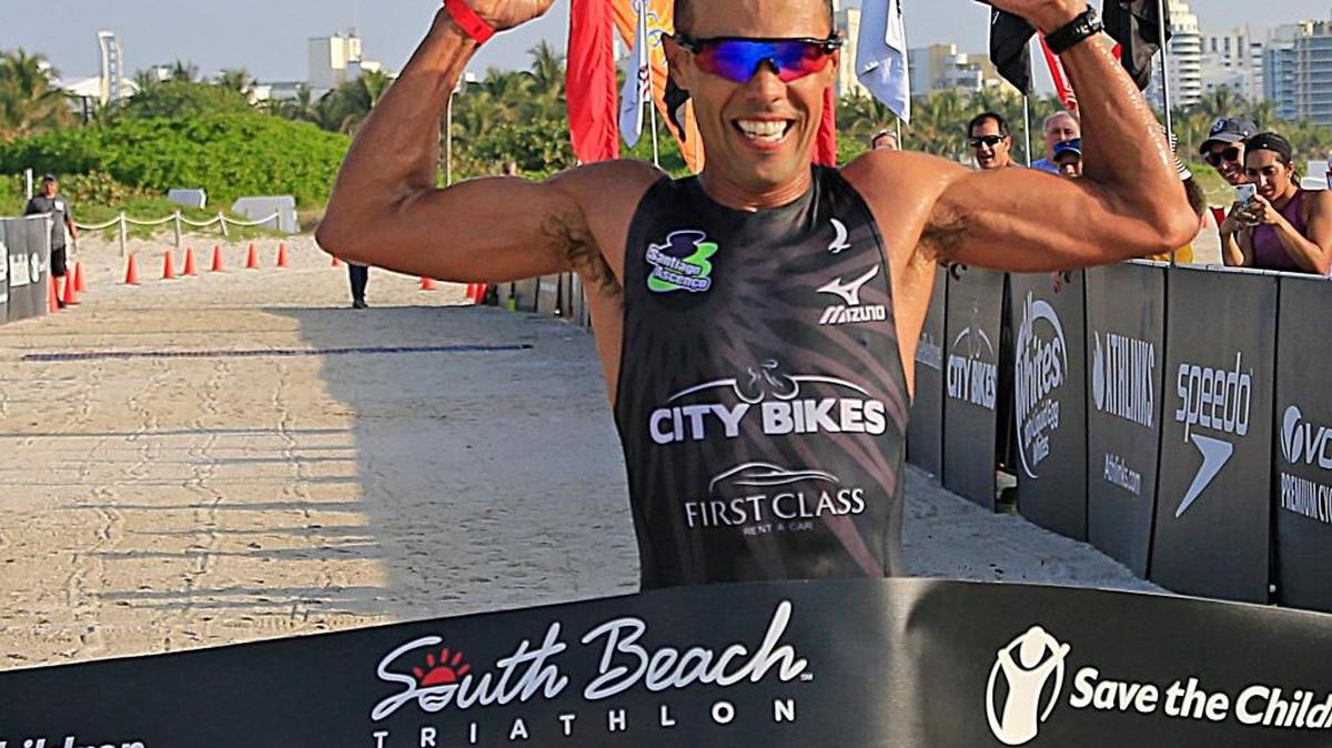 Brazilian triathlete Santiago Ascenco, 38, wins his first South Beach Triathlon as he crosses the finishing line.