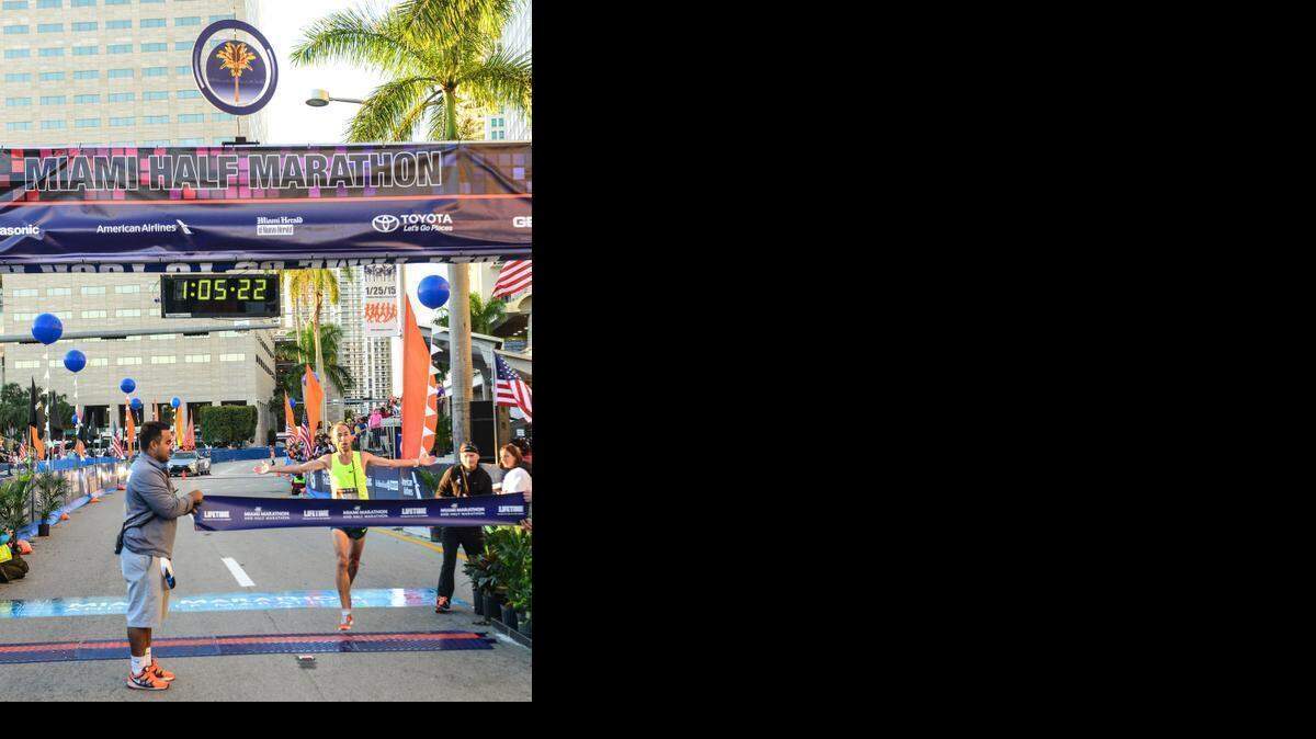 
Mariano Mastromarino, the first place half marathon finisher, runs through the finish line during the 2015 Miami Marathon & Half Marathon at the starting line in front of the AmericanAirlines Arena on Sunday, Jan. 25, 2015. Mastromarino, of Argentina, finished in 1:05:23.
