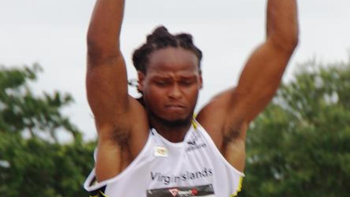 
Leon Hunt of the Virgin Islands strains for height in the long jump.
