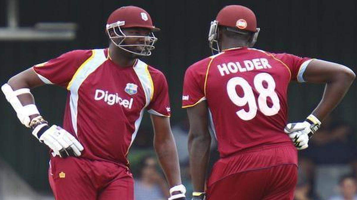 
West Indies teammates Sulieman Benn, left, and Jason Holder chat between overs during a One Day International against South Africa on Jan. 21, 2015. 

