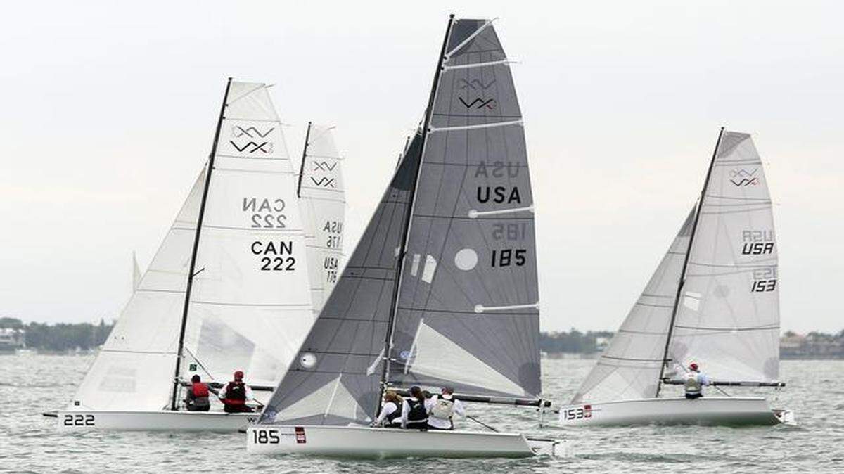 
Three VX One sailboats compete in the 2015 BACARDI Miami Sailing Week on March 7, 2015. From left, 222 (Canada — Paul Currie, Brad Funk); USA (Phillip Norris, Chris Norris, Brenna Paes); USA (Christian Koppernaes, Hayden Bennet). Presented by EFG Bank, the multi-class regatta drew teams from around the world, competing in five classes. Saturday capped a week of racing on Biscayne Bay.
