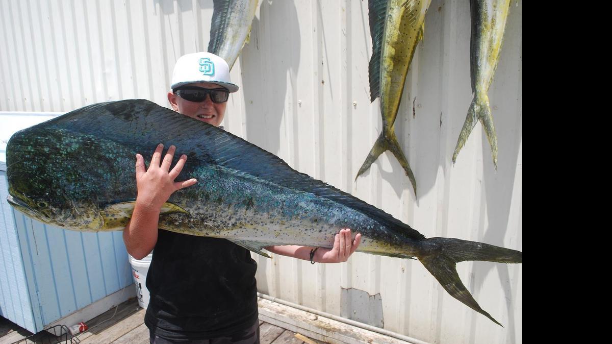 
Dillon Klais, 12, shows off the 48-pound dolphin he caught while fishing with brother Colton, 15, and grandfather Peter Mayclin aboard Capt. Shannon Attales’ Warbird charter boat.

