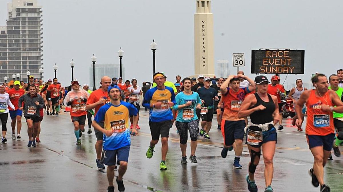 On Sunday, January 29, 2017 thousands of runners make their way westbound on the Venetian Causeway under cold and wet conditions during the Miami Marathon.