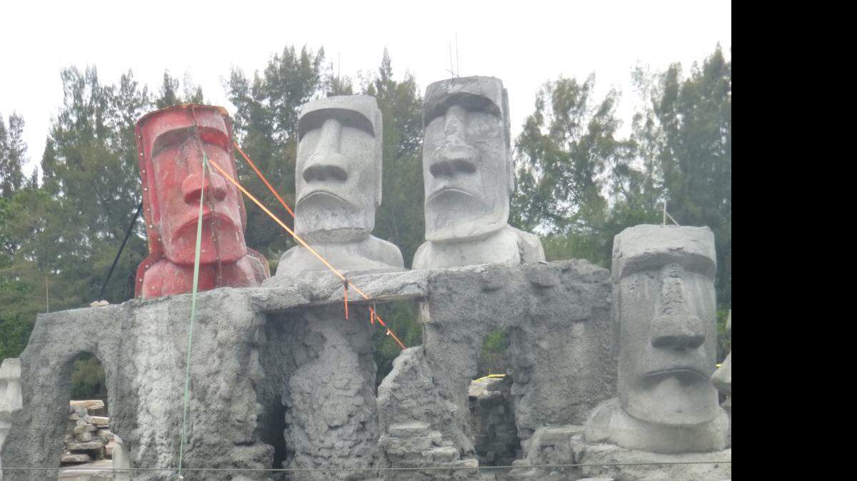 
The partially-finished Rapa Nui Reef on a barge in Stuart. The reef will pay tribute to the iconic stone figures on Easter Island. The left-most figure in red is encased in a fiberglass mold.
