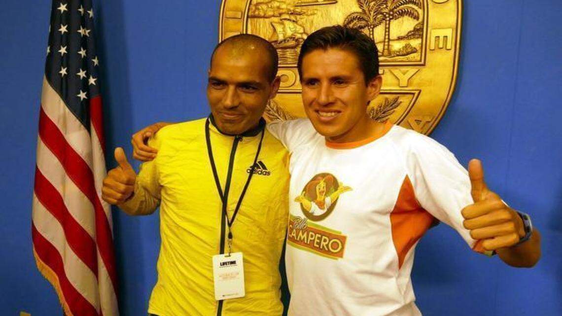 
Benazzouz Slimani, who won the Miami Marathon in 2009, and 2013 winner Luis Carlos Rivero pose for a picture at a press conference for the Miami Marathon Friday Jan. 23, 2015.
