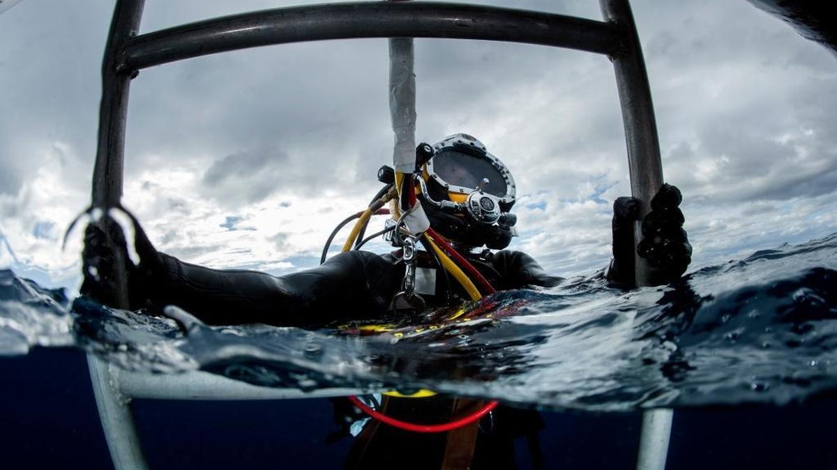 A sailor assigned to an Underwater Construction Team climbs a ladder after diver-qualification training off the coast of U.S. Navy base Guantánamo on Feb. 12, 2017, in this Navy photo.