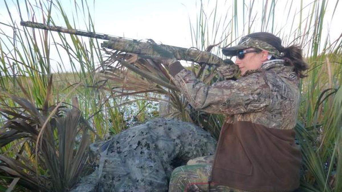 
Farrah Lemanski of Vero Beach aims her shotgun at a flight of ring-necked ducks flying over Lake Okeechobee.
