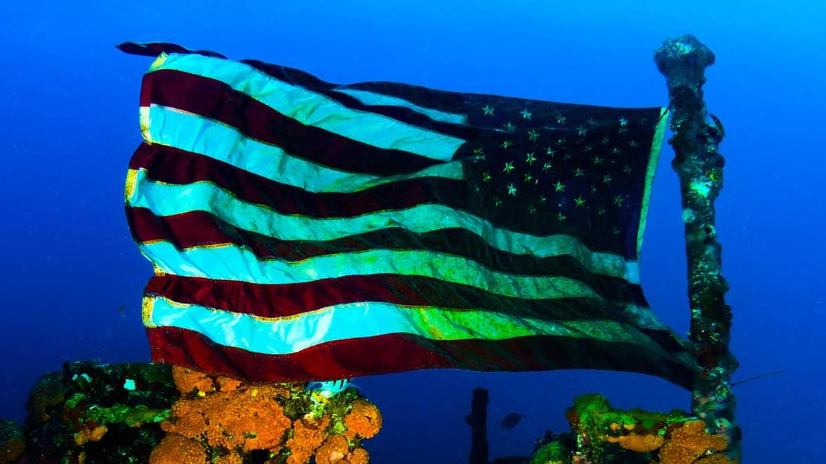 After reaching the bridge of the sunken USS Duane on a dive the day after Memorial Day, an American flag that someone put up had appeared. The current increased, and the flag fluttered in a patriotic moment.