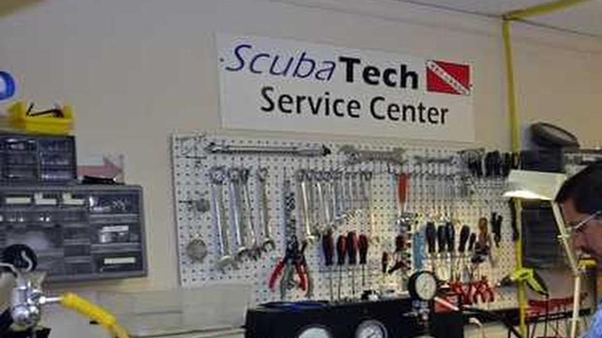 
Angel Fernandez, the owner of ScubaTech who has certified thousands of divers, checks dive equipment at his Key Largo shop. Fernandez, who completed the PADI Gold Program, worked for Divers Den and Austin Dive Center before opening his own shop.
