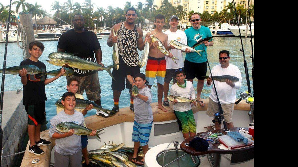 
Miami Dolphins defensive end Olivier Vernon (back row, second from left) is pictured during the Fins Weekend Fishing Tournament. 
