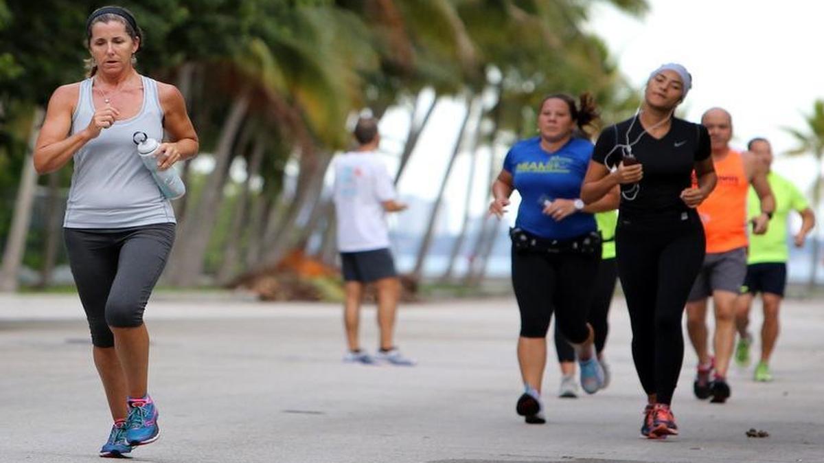 
Dorothy Campbell of Miami Shores trains with a group of runners participating in a free iRun training session in the Morningside neighborhood Thursday evening, July 23, 2015. 
