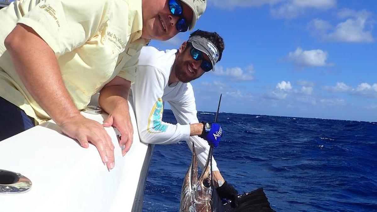 Mate Abie Raymond prepares to release a sailfish caught by Howard Walters of Pembroke Pines aboard Bouncer’s Dusky 33.