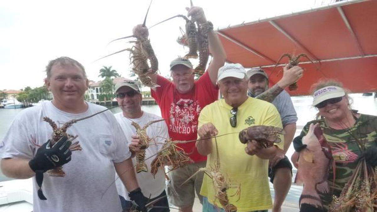 
From left: Bill Barnes, Ken Udell, Jim “Chiefy” Mathie, Tom Campbell, John Strunk, and Heather Schaefer display part of their catch of 29 lobsters harvested off Lauderdale-By-The-Sea.
