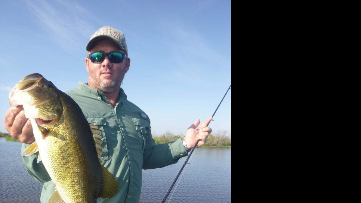 
Byron Hennecy of St. Cloud holds up a nice largemouth bass caught using a swim bait in the Upper St. Johns River Marsh.
