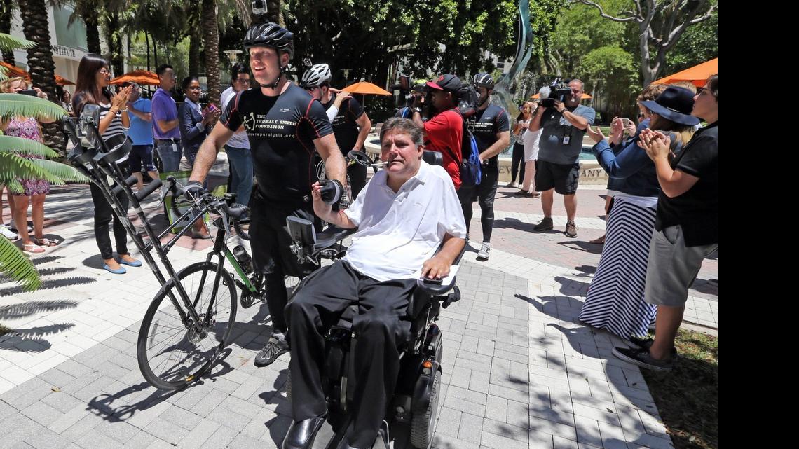 
Tom Smith, from Swampscott Massachusetts, walks with Marc Buoniconti into the The Miami Project to Cure Paralysis building, May 1, 2015. Smith rode his bike from Massachusetts to the Paralysis Center in Miami and is a former patient of University of Miami Neurosurgeon and Miami to Cure Paralysis Founder Dr. Barth Green> He was twice paralyzed playing hockey.
