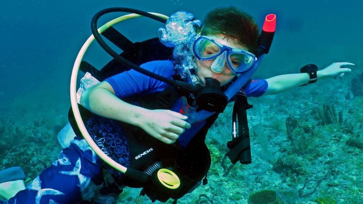 
Thomas Rhodes, 11, participates in a dive with his grandfather, instructor Don Rhodes, on two reefs off Islamorada in the Florida Keys recently.

