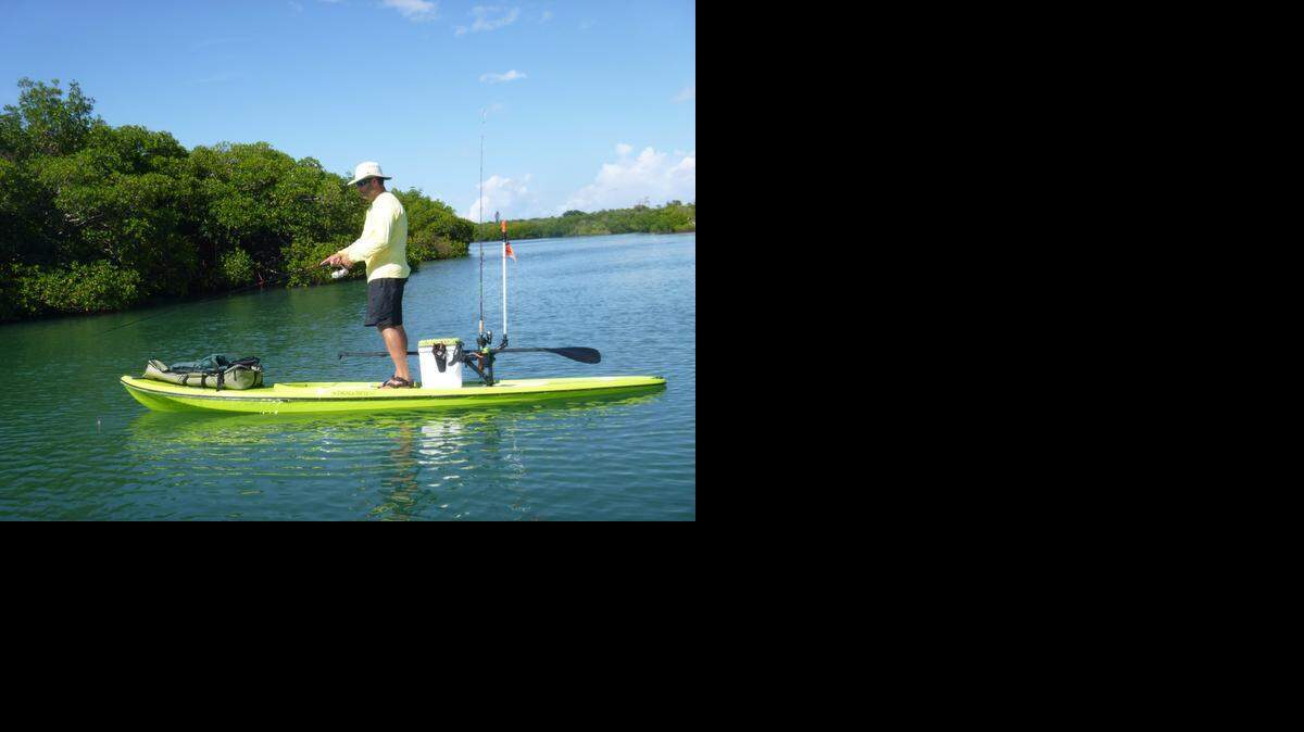 
Peter Hinck fishes from his stand-up paddleboard at North Hutchinson Island near Fort Pierce.
