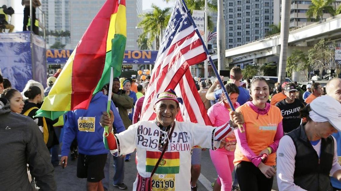 A runner from Bolivia finishes the half marathon during the 2016 Miami Marathon and Half Marathon. Race organizers have set up cheer zones for spectators.