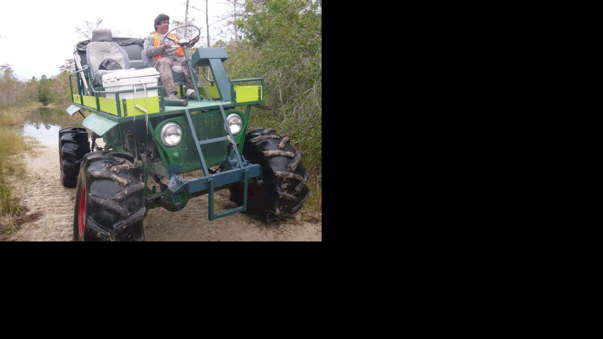 
Ozzie Gonzalez steers his swamp buggy down a trail through the Big Cypress National Preserve on a recent deer hunting trip.
