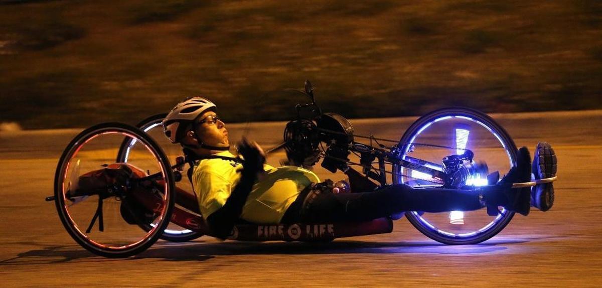 A marathoner breathes deep as he ascends the MacArthur Causeway bridge on his recumbent bike to head east toward Miami Beach during the Miami Marathon and Half Marathon on Sunday, Jan. 28, 2018.