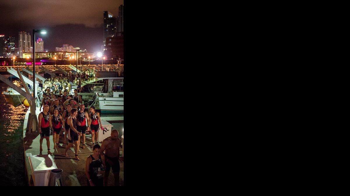 
Participants prepare for the first leg of the Escape to Miami Triathlon on Sunday, Sept. 28, 2014.
