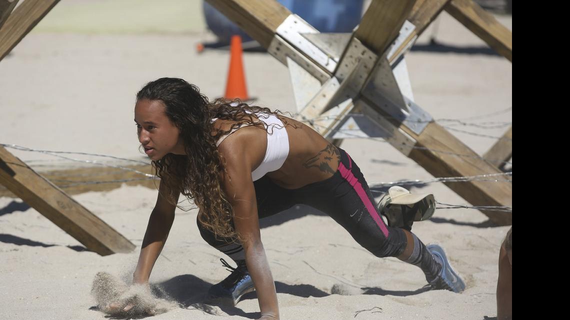 
Sweetwater’s Lily Garcia takes on a barbed-wire obstacle in a BattleFrog obstacle course race at Lummus Park in South Beach in 2014. The series returns to Miami on Nov. 21 at Amelia Earhart Park.

