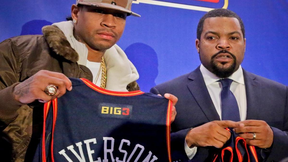 Former NBA player Allen Iverson, left, shows his jersey as he poses with entertainer Ice Cube after they announced the launch of the BIG3, a new 3-on-3 professional basketball league.