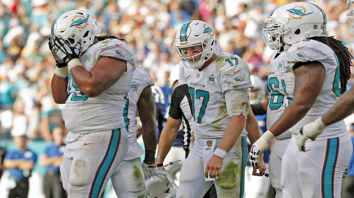 Jamil Douglas buries his head in his hands after his premature snap to Ryan Tannehill (17) led to a sack on the final play.