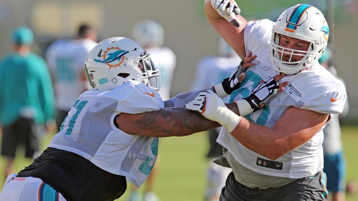 A knee injury to Kraig Urbik (right) thrust Jesse Davis to the precipice of the Miami Dolphins starting left guard job.