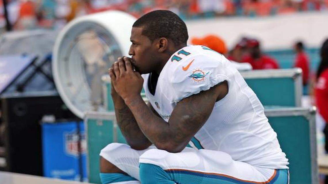 
With the offense on the field Miami Dolphins wide receiver Mike Wallace sits on the bench in the final minutes of the fourth quarter as they play the New York Jets at Sun Life Stadium in Miami Gardens on Sunday, Dec. 28, 2014.
