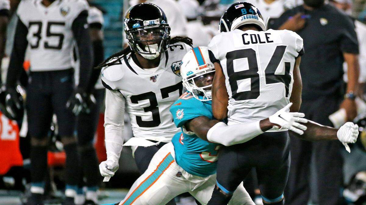 Miami Dolphins cornerback Chris Lammons (30) tackles Jacksonville Jaguars Keelan Cole (44) on a first quarter kick off at Hard Rock Stadium in Miami Gardens, Florida, Thursday, August, 22, 2019.
