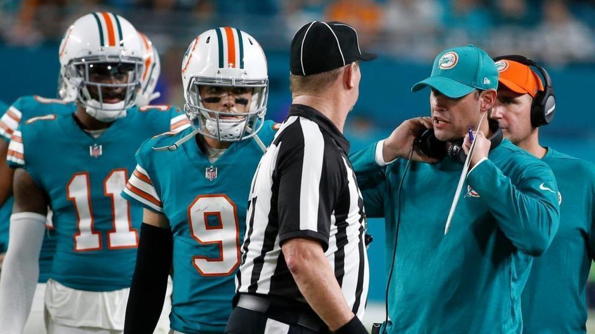 Miami Dolphins head coach Adam Gase talks to side judge Terry Brown after several players were ejected during the second half of Sunday’s game against the Buffalo Bills. To the left are Miami Dolphins quarterback David Fales (9) and wide receiver DeVante Parker (11).