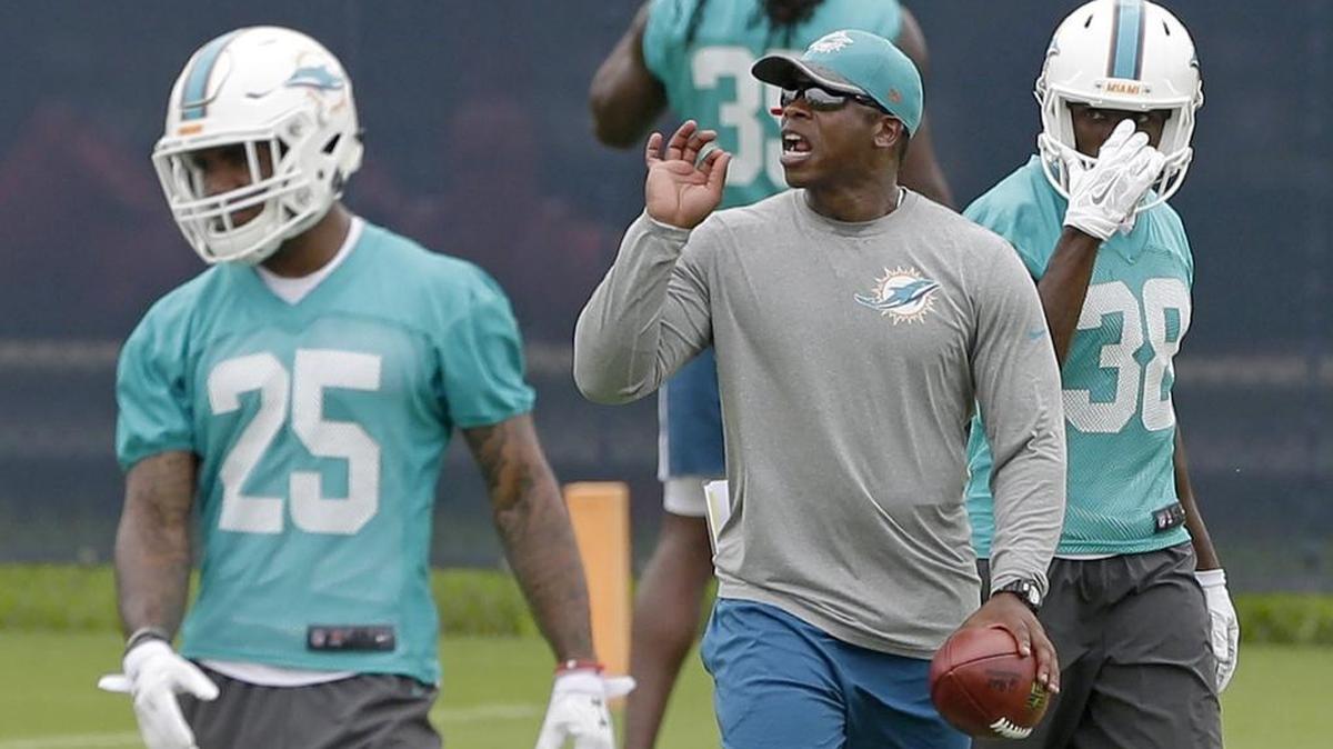Dolphins defensive coordinator Vance Joseph, center, is using a variety of players to make up for the loss of safety Reshad Jones.