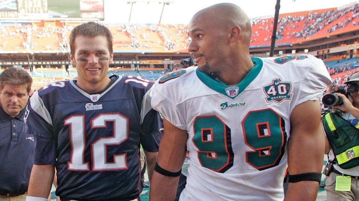 From the archives: Tom Brady and Jason Taylor leave field together as the Miami Dolphins host the New England Patriots at Dolphins Stadium in Miami.