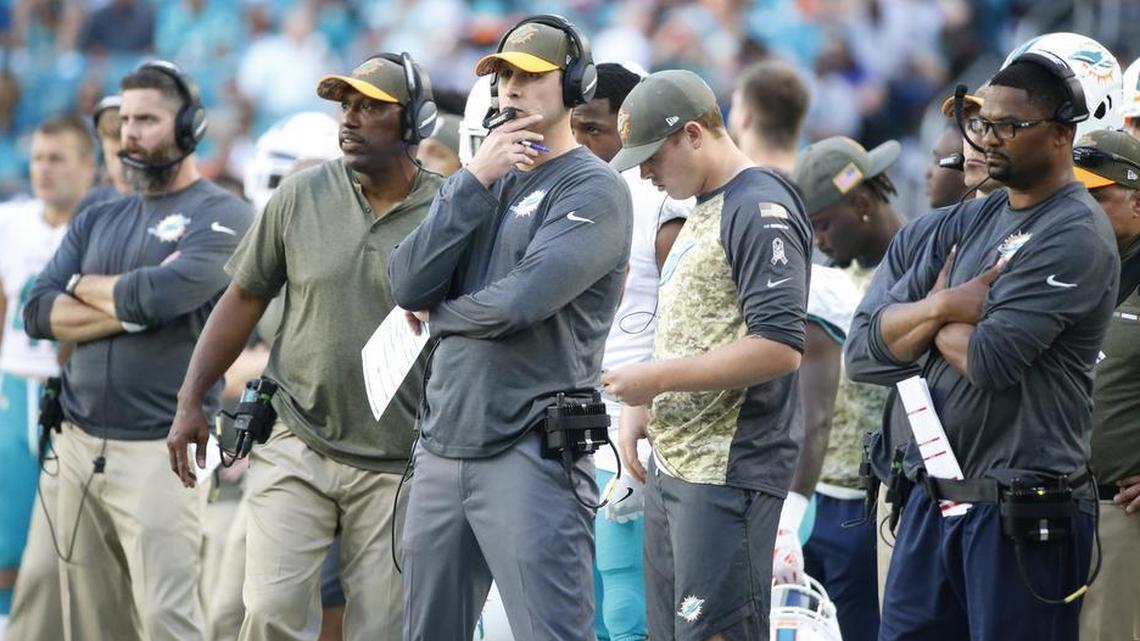 Miami Dolphins head coach Adam Gase and some of his assistants look on during the second half of a loss against the Tampa Bay Buccaneers.