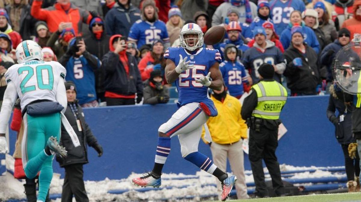 Buffalo Bills running back LeSean McCoy (25) catches a pass for a touchdown in front of the Miami Dolphins' Reshad Jones (20) during the first half Sunday, Dec. 17, 2017, in Orchard Park, N.Y.