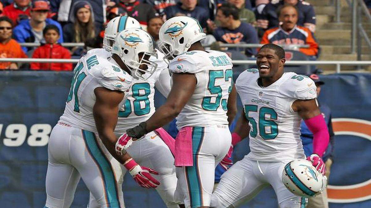 <z_idx_alfa><cutline_leadin>Next step:</cutline_leadin> Cameron Wake, left, celebrating a sack against Chicago last Sunday, said the Dolphins have excelled in many areas this season, ‘But doing it all consistently, together, collectively as a unit, I think that’s been some of the issues.’<252></z_idx_alfa>