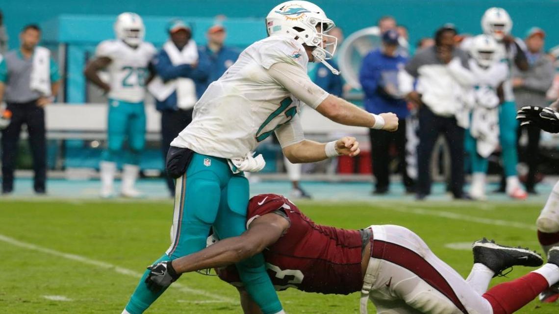 Arizona Cardinals defensive end Calais Campbell (93) tackles Miami Dolphins quarterback Ryan Tannehill (17), during the second half of an NFL football game, Sun., Dec. 11, 2016, in Miami Gardens, Fla. Tannehill was injured on the play.