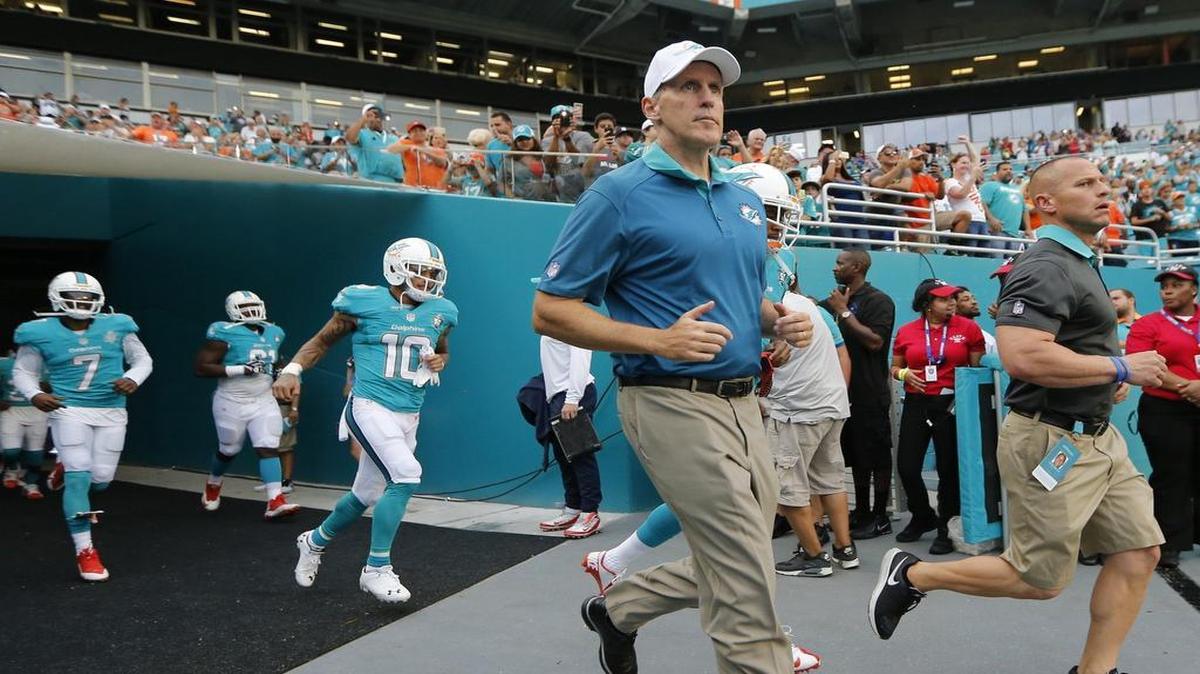 
Dolphins head coach Joe Philbin runs out during the Miami Dolphins' exhibition game against the Atlanta Falcons at Sun Life Stadium on Saturday, August 29, 2015.
