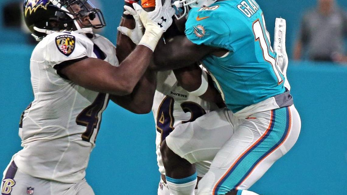 Dolphins Jakeem Grant fights Ravens Anthony Levins for the ball in a preseason game earlier this month.