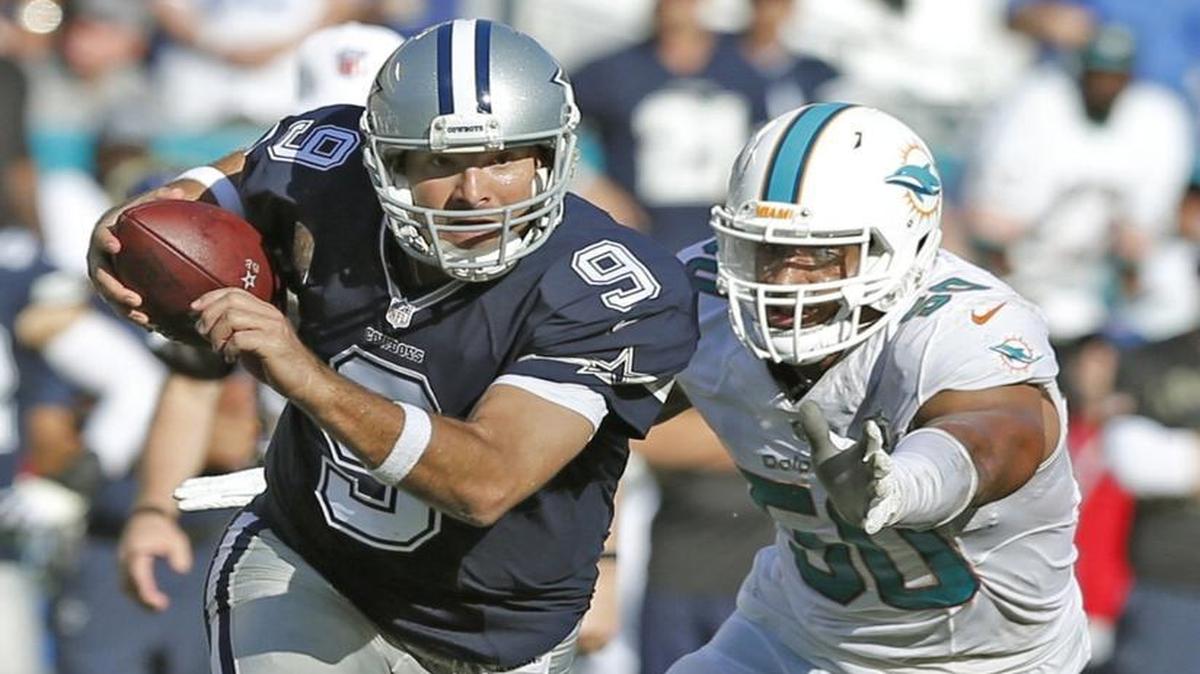 Dallas Cowboys quarterback Tony Romo (9) is persued by Miami Dolphins defensive end Olivier Vernon (50) in the fourth quarter as the Miami Dolphins host the Dallas Cowboys at Sun Life Stadium on Sunday, November 22, 2015