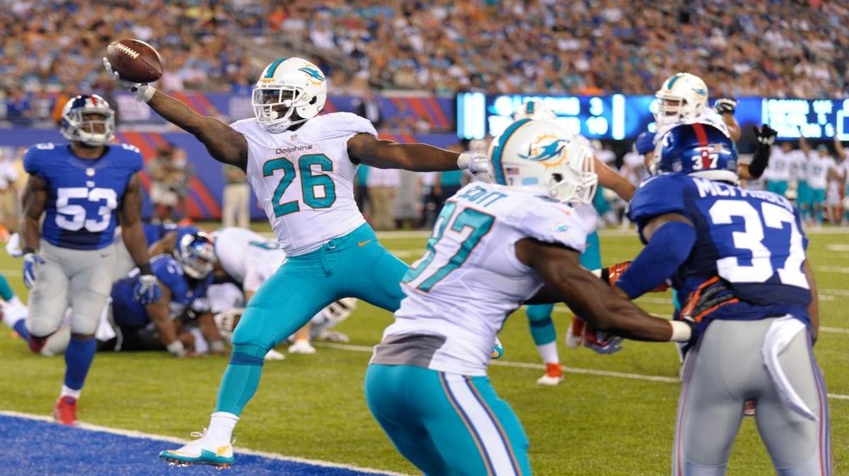 Miami Dolphins running back Damien Williams (26) scores a touchdown against the New York Giants during the second quarter of a preseason NFL football game, Fri., Aug. 12, 2016, in East Rutherford, N.J.
