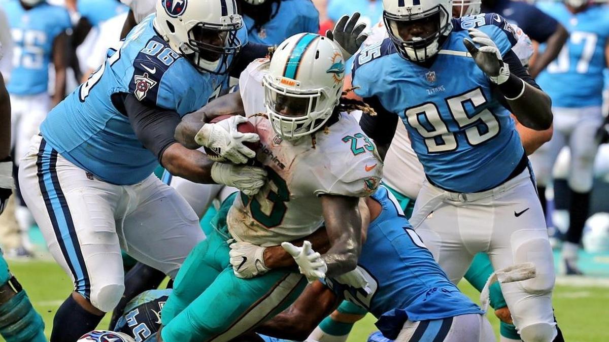 Miami Dolphins Jay Ajayi (23) fights his way through the Tennessee Titans defense in the fourth quarter at Hard Rock Stadium in Miami Gardens, Florida, Oct. 8, 2017.