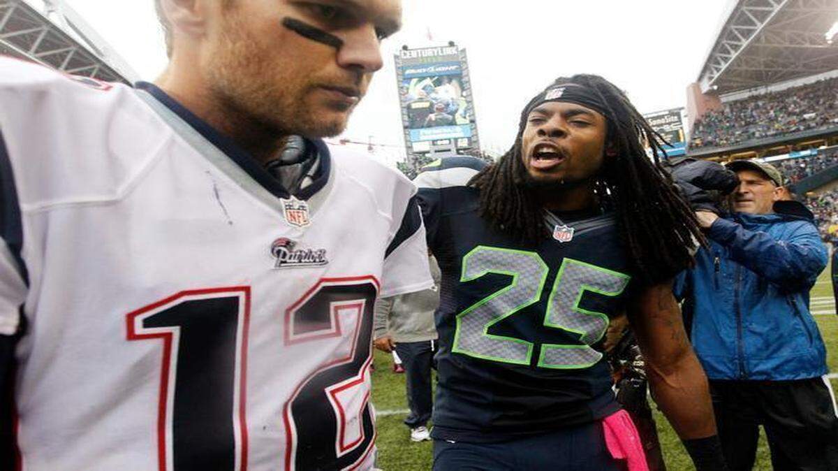 
A mouthful: The brash, outspoken Richard Sherman, right, gives Patriots quarterback Tom Brady a message after Seattle’s 24-23 win in October 2012 in a way only the Seahawks cornerback can. Sherman, who graduated from Stanford, says he is considering a career in politics when his playing days have come to an end.
