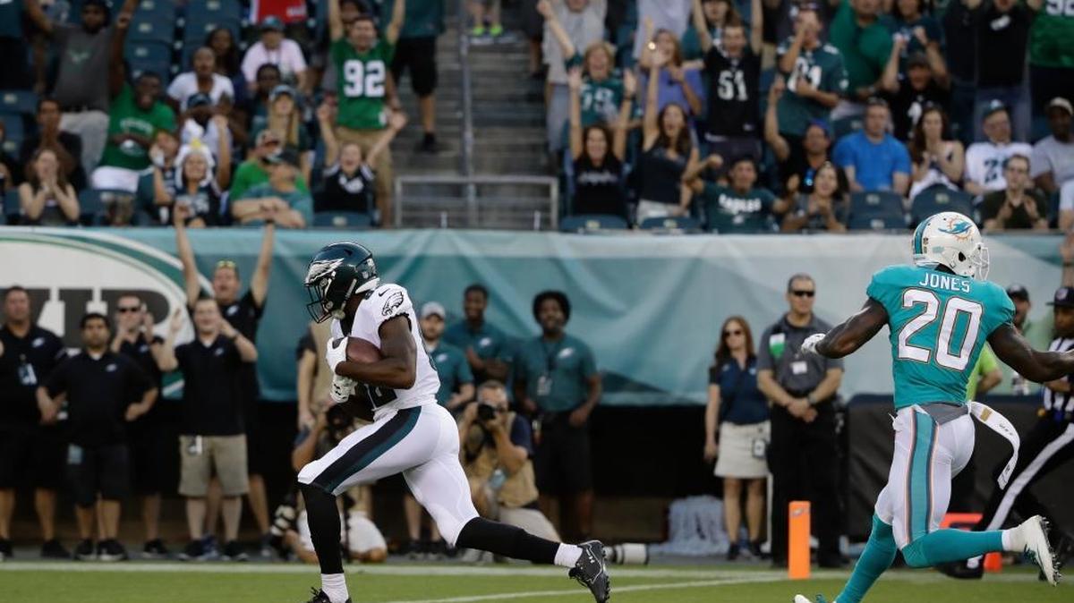 Eagles receiver Torrey Smith scores as Dolphins safety Reshad Jones yells at cornerback Byron Maxwell about the coverage.