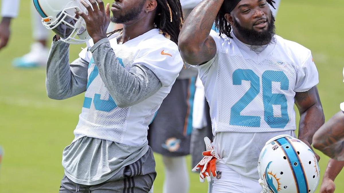 Running back Jay Ajayi (23) and Damien Williams (26) between drills during Dolphins minicamp.