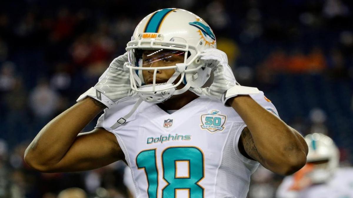 Miami Dolphins wide receiver Rishard Matthews adjusts his helmet before an NFL football game against the New England Patriots, Thursday, Oct. 29, 2015, in Foxborough, Mass.