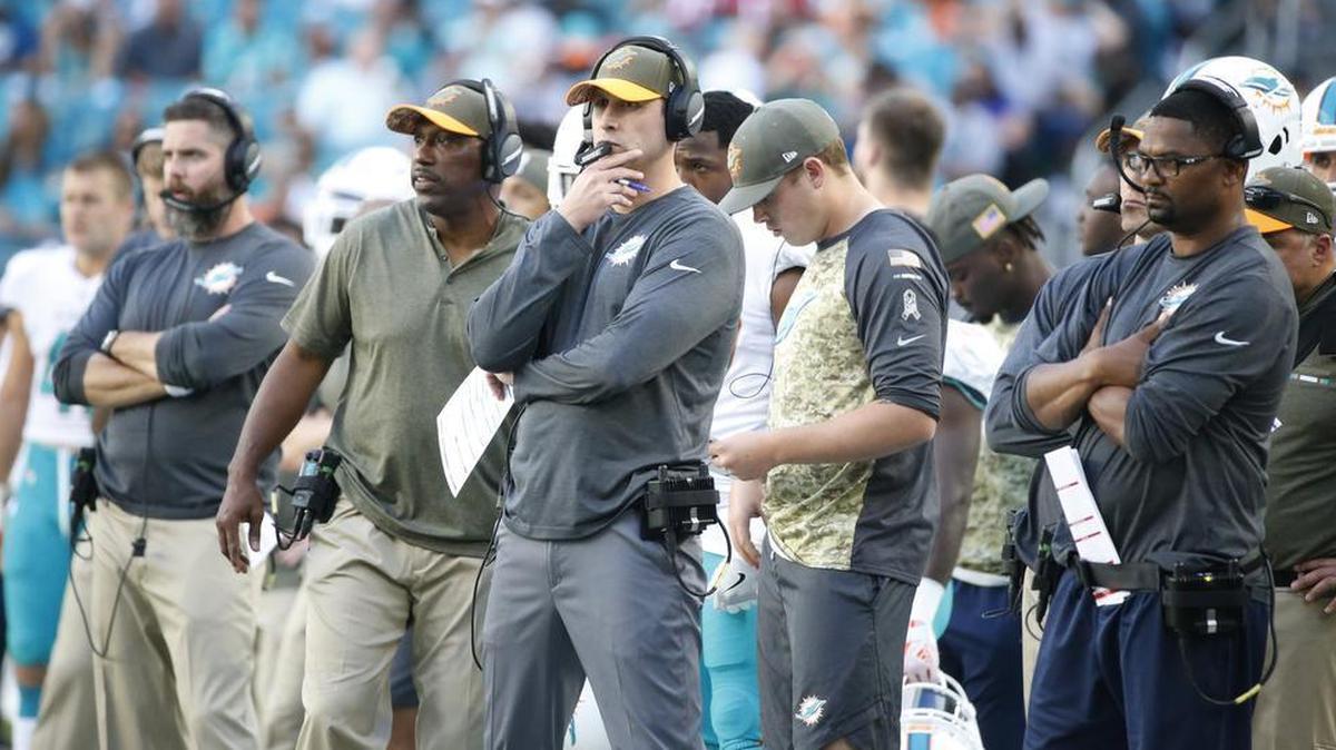 Miami Dolphins coach Adam Gase and his assistants look from the sidelines during their loss against the Tampa Bay Buccaneers on Nov. 19, 2017. On Sunday, Nov. 26, 2017, Miami takes on New England.