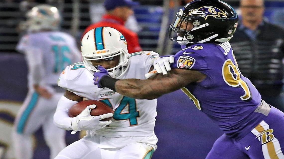 Miami Dolphins Jarvis Landry is tackled after a reception by Baltimore Ravens Matthew Judon in the first quarter Thursday night.