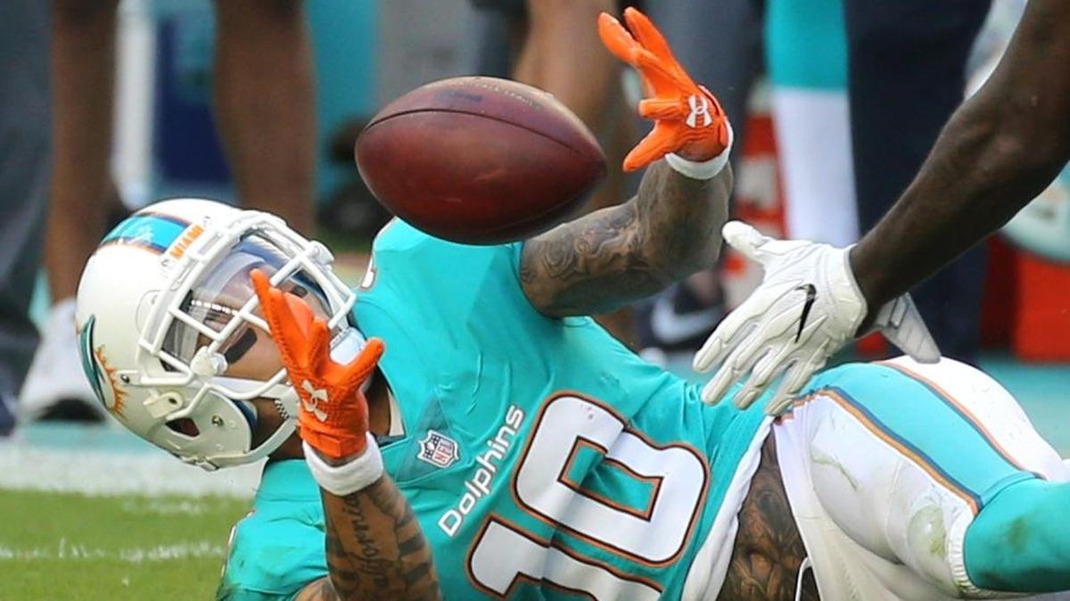 Miami Dolphins Kenny Stills (10) catches a circus pass in the first quarter as they play the Denver Broncos at Hard Rock Stadium in Miami Gardens, Florida, Dec. 3, 2017.